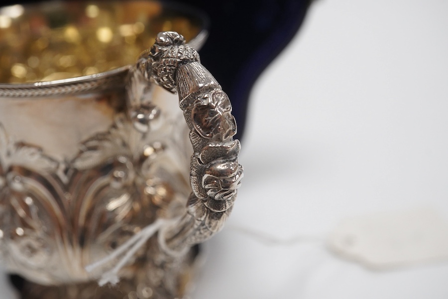 A cased William IV embossed silver pedestal christening mug, with engraved monogram, by Pearce & Burrows, London, 1831, height 77mm, 3.4oz. Condition - fair